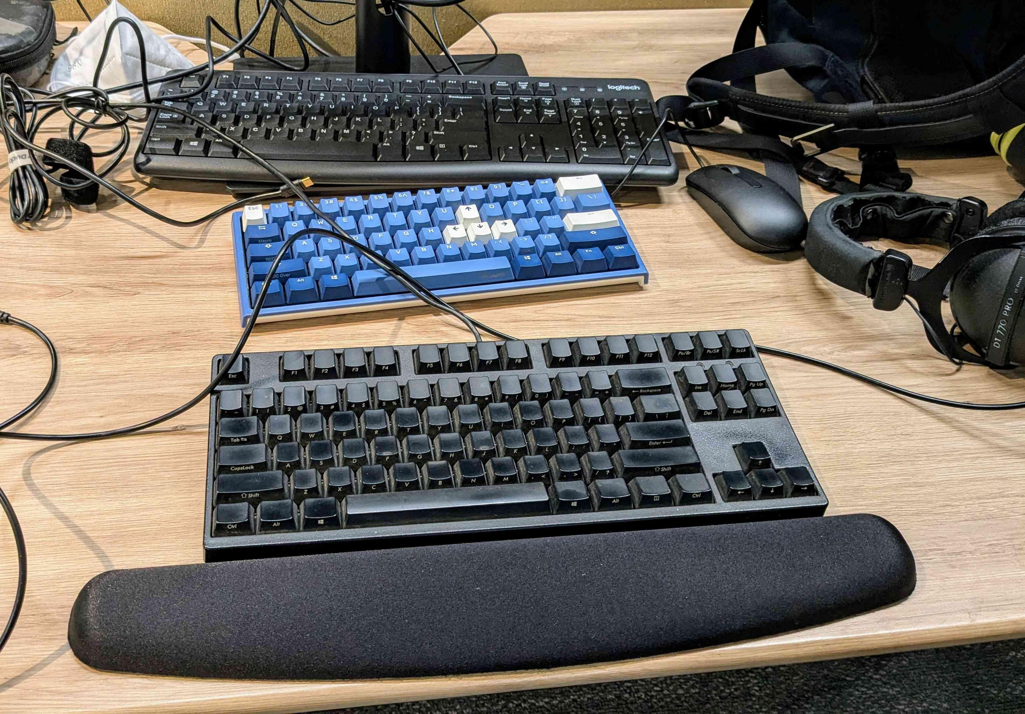 a photograph of Logitech, Ducky, and Filco keyboards on a desk.