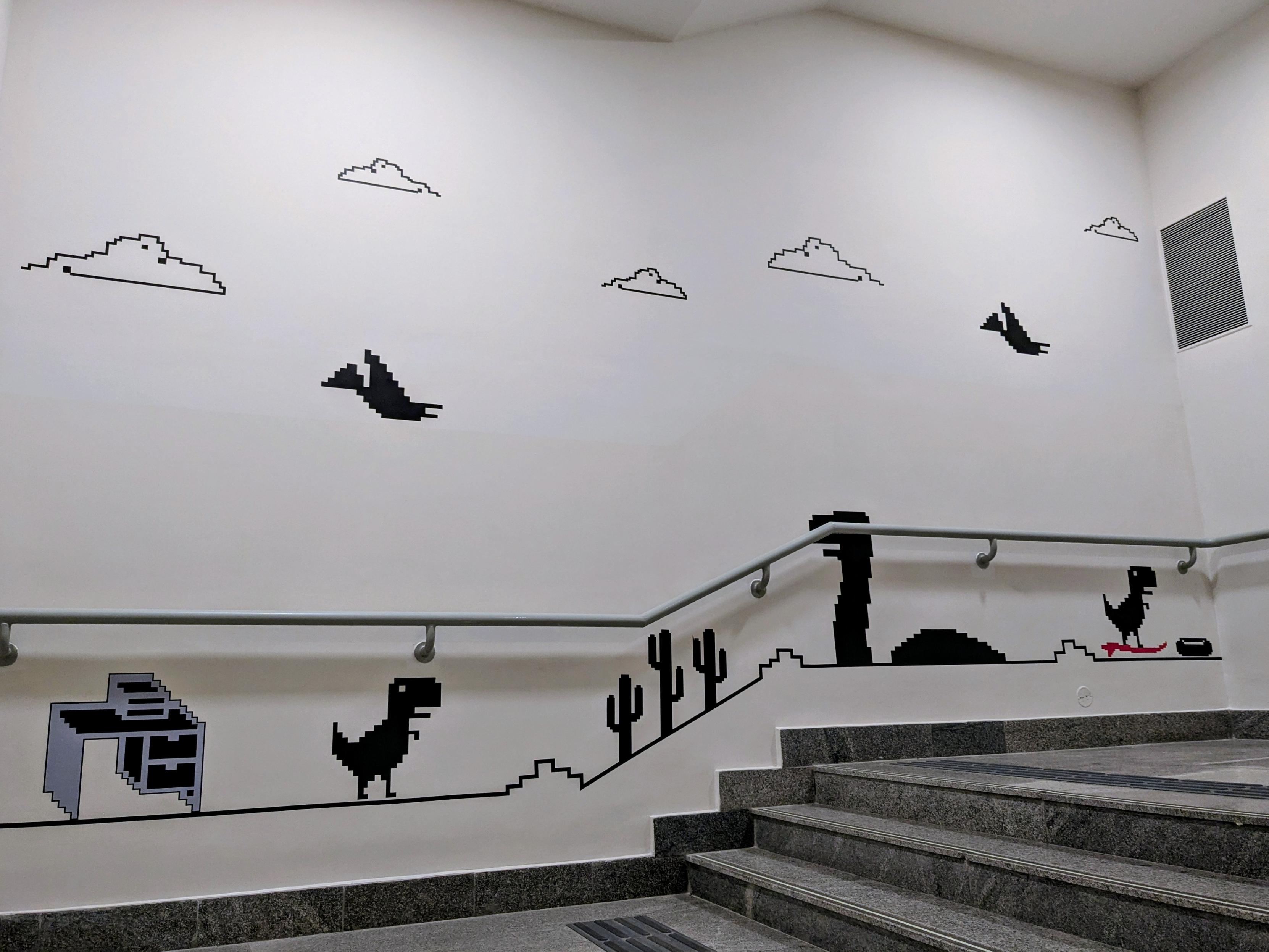 photo of a wall mural that is the dinosaur game you can play in Google Chrome browser at chrome://dino